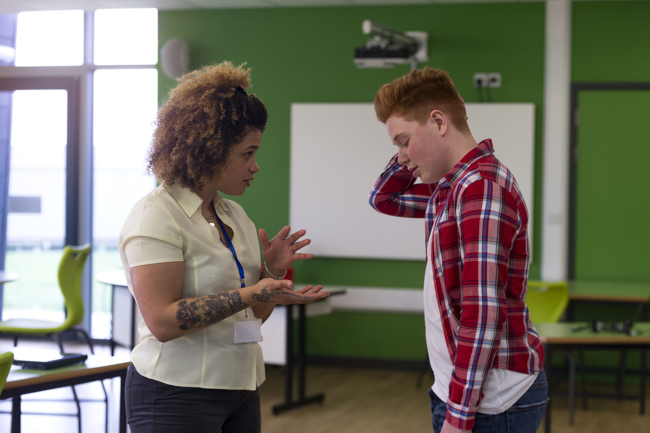 teacher speaking to frustrated student- de-escalation tips for teachers