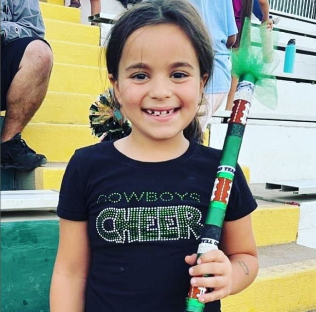 Student holding a school spirit stick